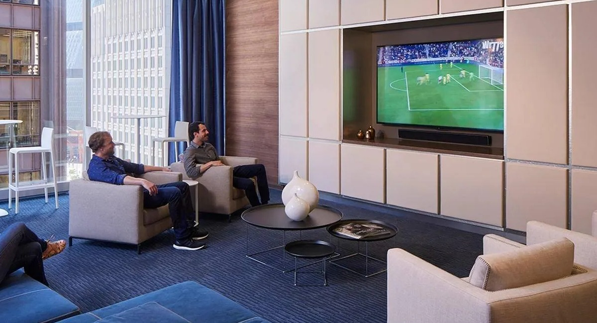 Cozy media lounge with plush seating and a large screen TV for entertainment at Marquee at Block 37 apartments in Chicago