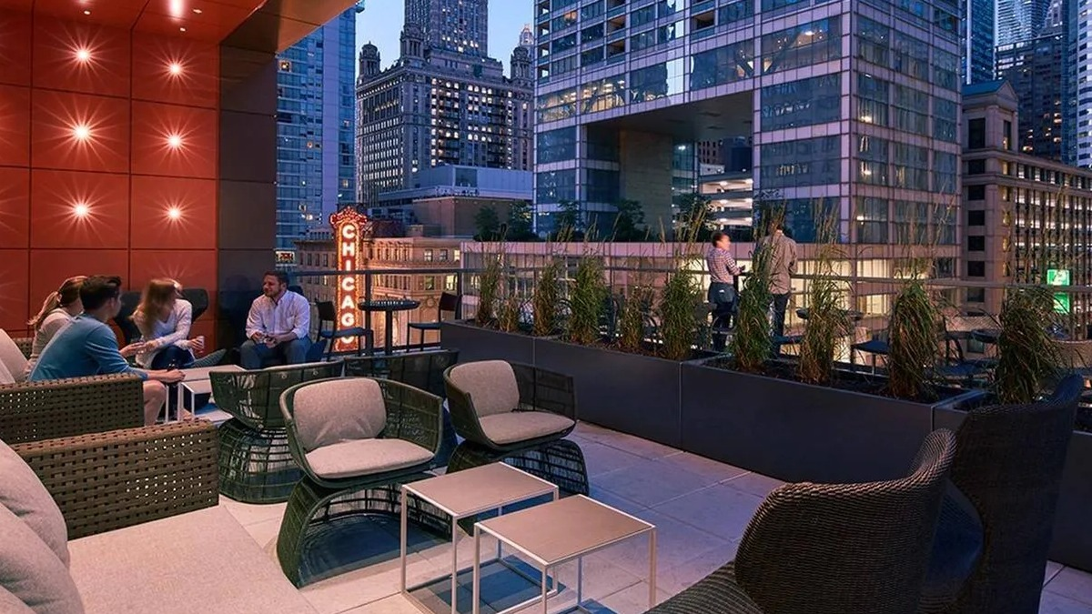 Residents relaxing on a modern rooftop lounge with comfortable seating and stunning city views at Marquee at Block 37 in Chicago