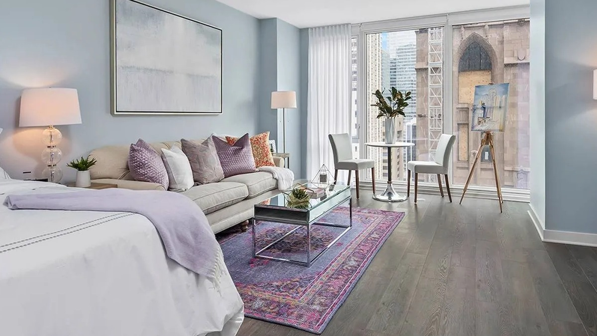 Bright studio apartment with a combined living and bedroom area, featuring large windows and modern decor at Marquee at Block 37 in Chicago