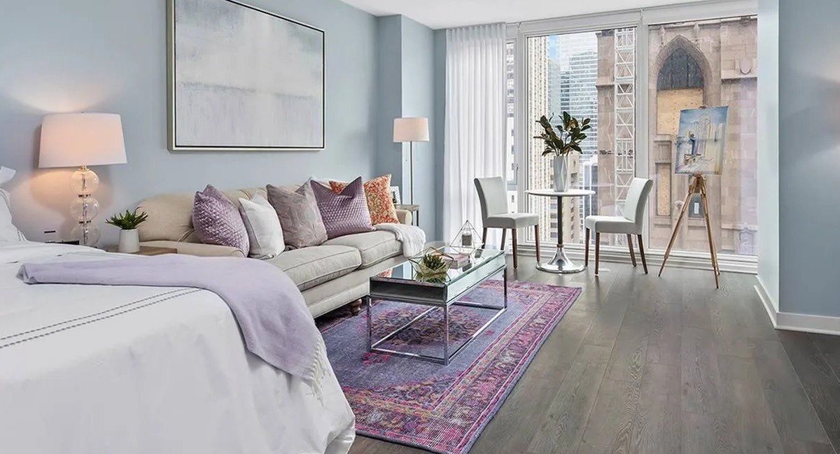 Bright studio apartment with a combined living and bedroom area, featuring large windows and modern decor at Marquee at Block 37 in Chicago
