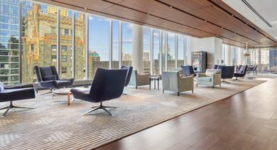 Luxurious resident lounge with comfortable seating and expansive windows offering panoramic city views at MILA Luxury Apartments in Chicago