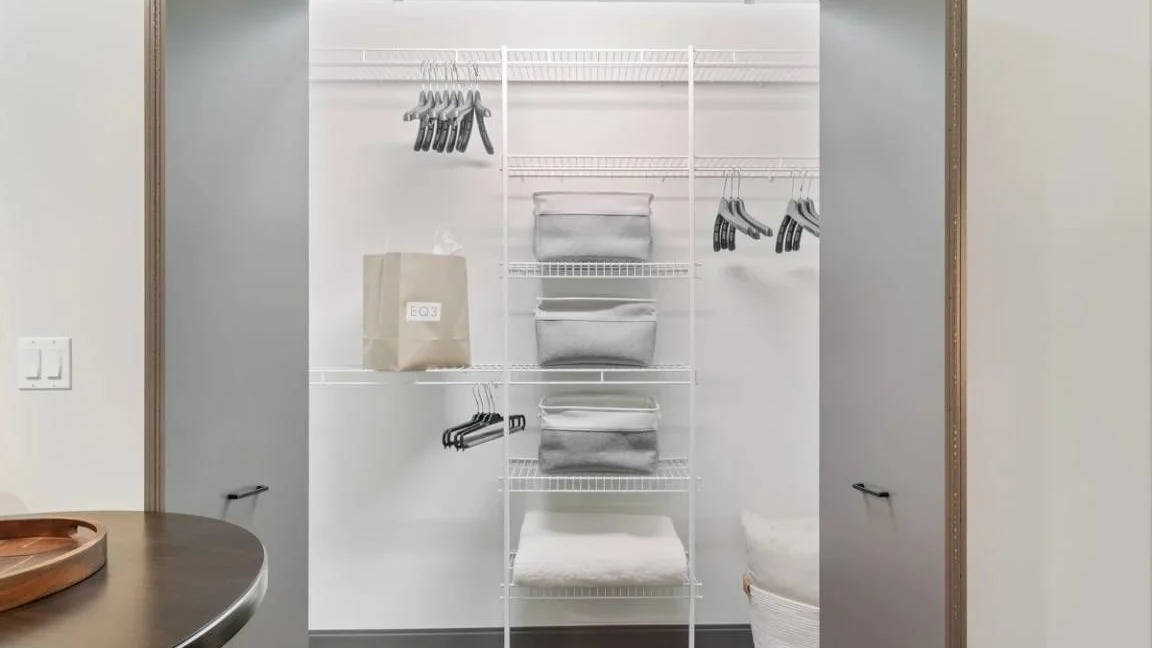 Organized bedroom closet with shelving, hangers, and ample space for clothes and belongings at Millennium on LaSalle in Chicago