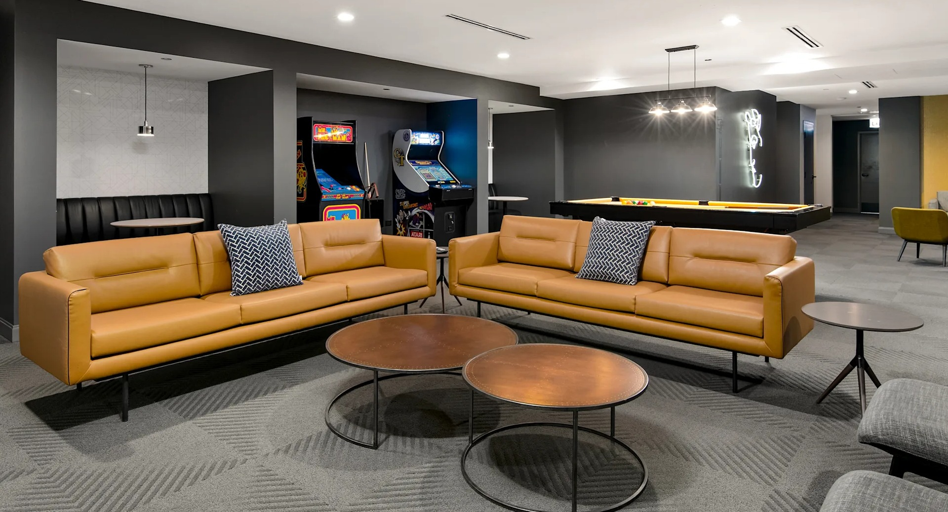 Fun-filled game room featuring arcade machines, comfortable seating, and a billiards table at Millennium on LaSalle in Chicago