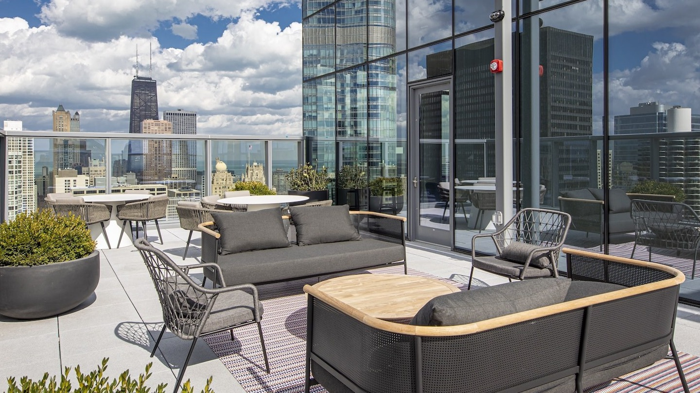 Luxurious rooftop lounge with comfortable seating and expansive city skyline views at Millie on Michigan in Chicago