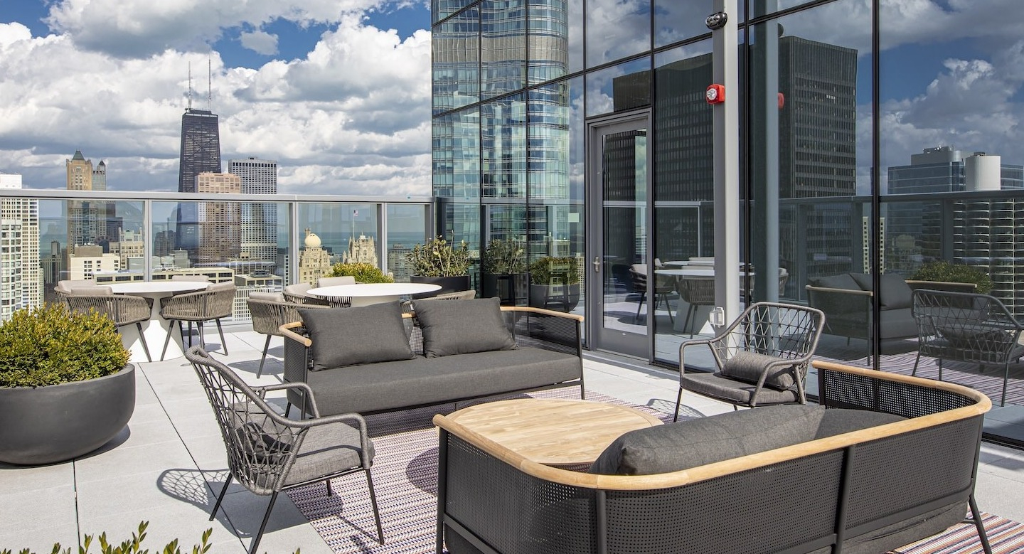 Luxurious rooftop lounge with comfortable seating and expansive city skyline views at Millie on Michigan in Chicago