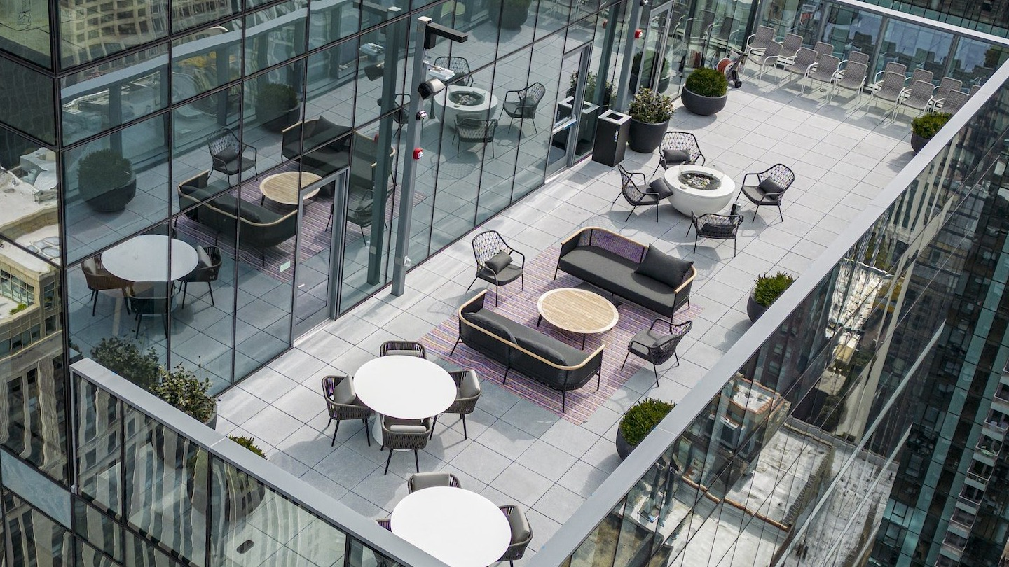 Expansive rooftop outdoor lounge with modern furniture and panoramic city views at Millie on Michigan Chicago