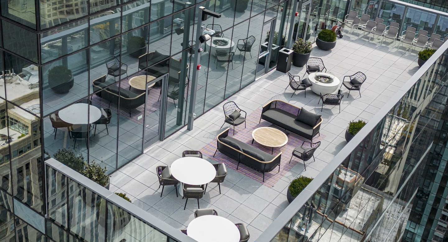Expansive rooftop outdoor lounge with modern furniture and panoramic city views at Millie on Michigan Chicago