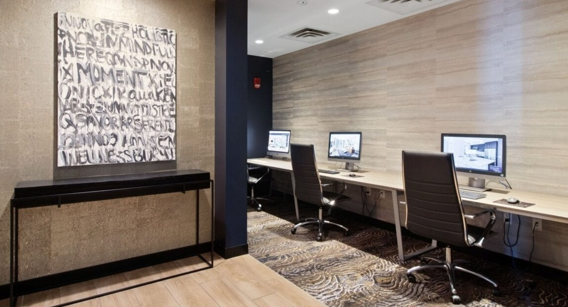 Dedicated resident work stations with computers and office chairs, ideal for productivity at Moment Apartments in Chicago