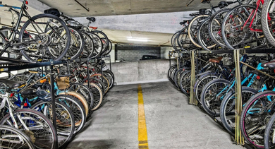 Secure and organized bike storage facility with multiple racks for residents' bicycles at Mondial River West apartments in Chicago