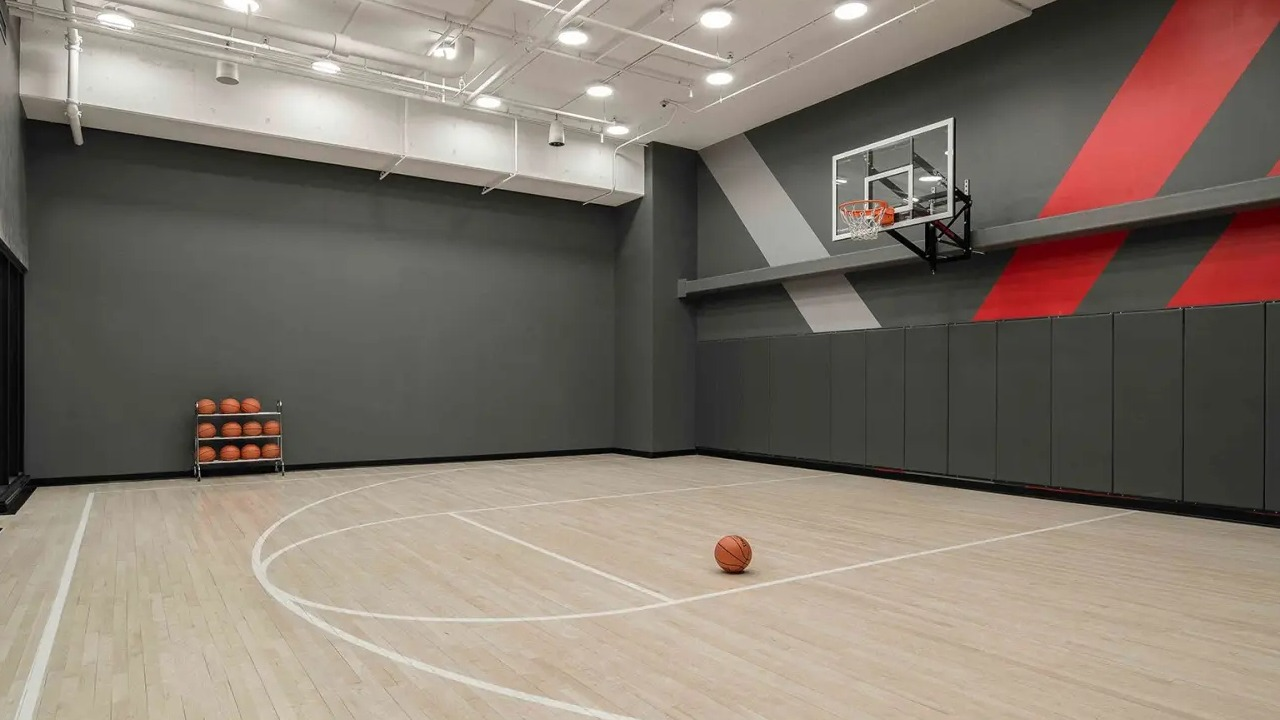 State-of-the-art indoor basketball court at NEMA Chicago, featuring a polished wooden floor and modern design for sports enthusiasts