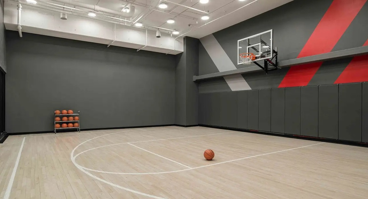 State-of-the-art indoor basketball court at NEMA Chicago, featuring a polished wooden floor and modern design for sports enthusiasts