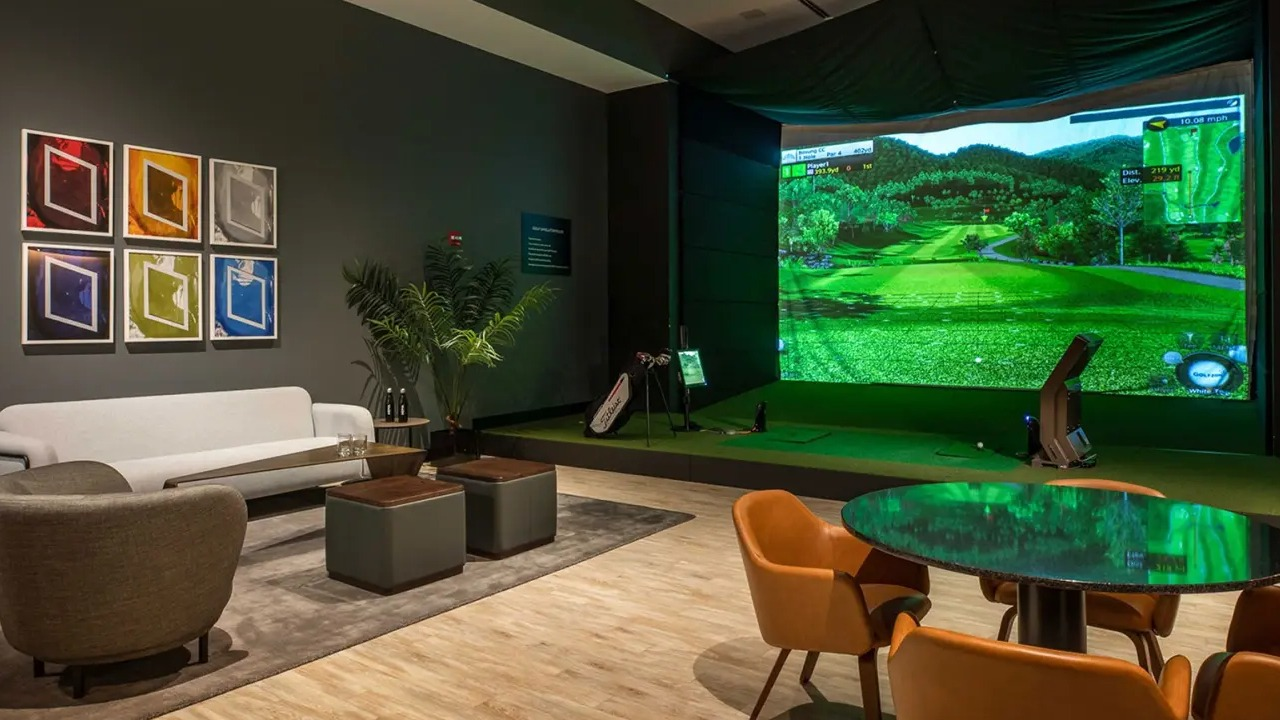 Sophisticated golf simulator lounge at NEMA Chicago, offering a virtual golfing experience, comfortable seating, and stylish decor