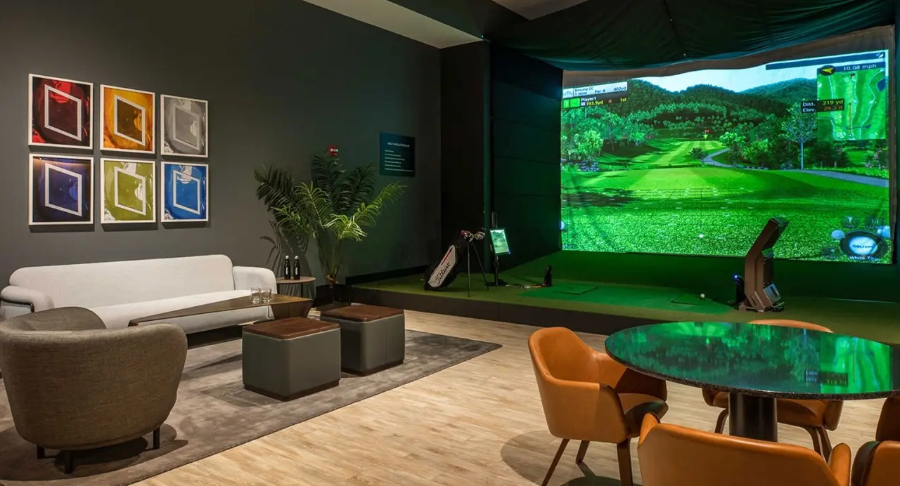 Sophisticated golf simulator lounge at NEMA Chicago, offering a virtual golfing experience, comfortable seating, and stylish decor