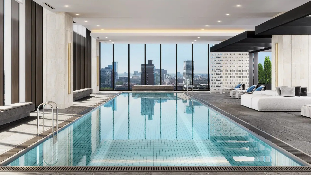 Luxurious indoor pool at NEMA Chicago, offering serene waters, comfortable lounging, and impressive city skyline views