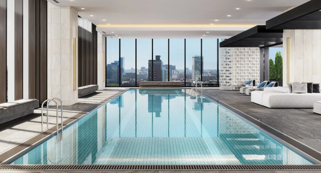 Luxurious indoor pool at NEMA Chicago, offering serene waters, comfortable lounging, and impressive city skyline views