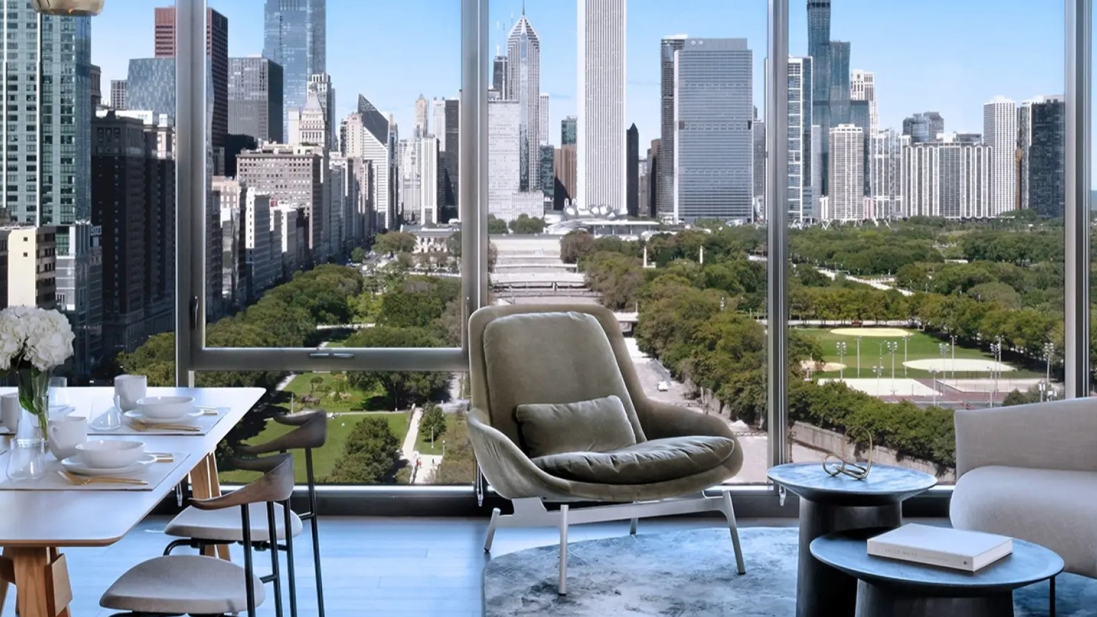 Elegant apartment living room at NEMA Chicago, offering breathtaking panoramic views of the city skyline and adjacent park
