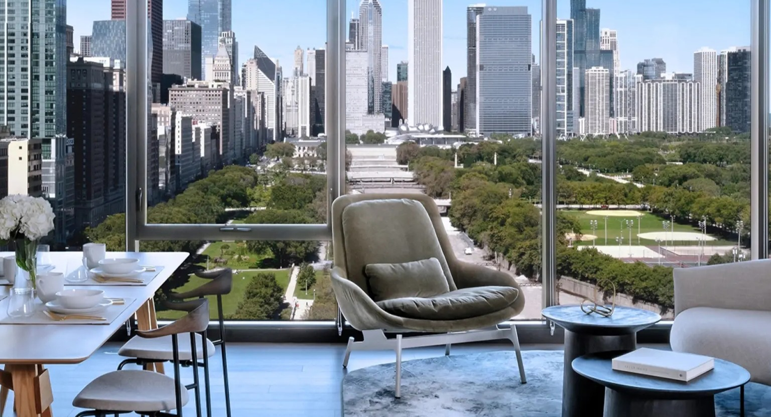 Elegant apartment living room at NEMA Chicago, offering breathtaking panoramic views of the city skyline and adjacent park