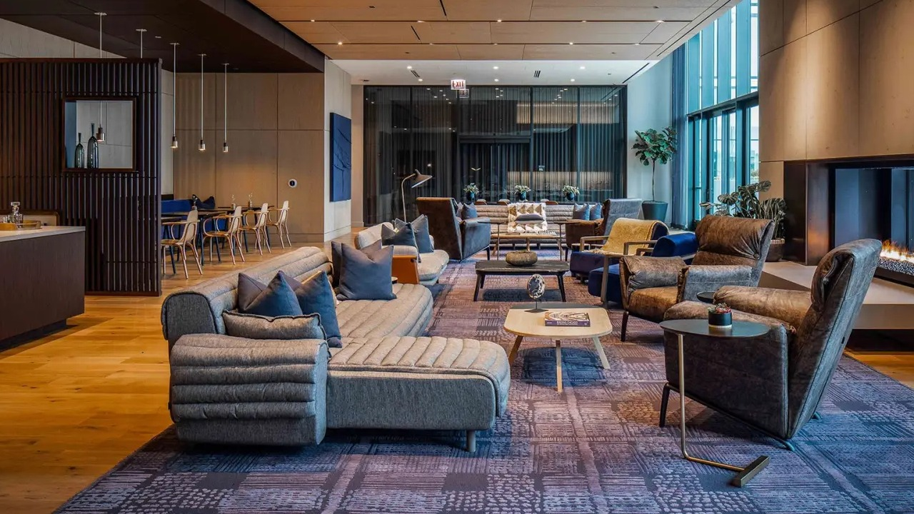 Expansive resident lounge at NEMA Chicago, featuring a cozy fireplace, comfortable seating areas, and modern decor for ultimate relaxation