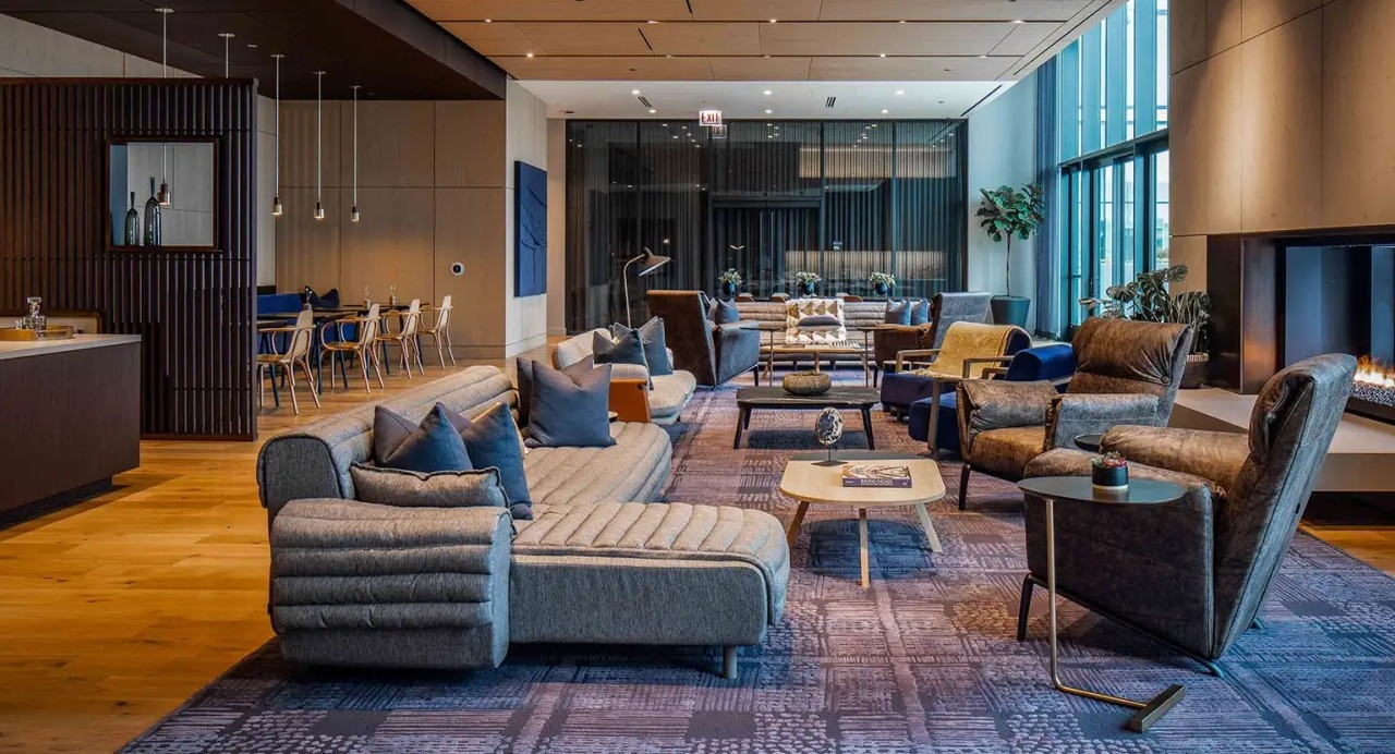 Expansive resident lounge at NEMA Chicago, featuring a cozy fireplace, comfortable seating areas, and modern decor for ultimate relaxation