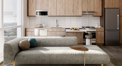 Modern apartment living area at Nevele22 in Chicago, featuring a cozy sofa, stylish coffee table, and a compact yet functional kitchenette