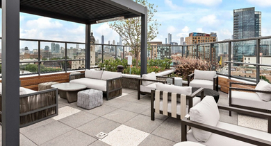 Luxurious rooftop lounge at Nevele22 in Chicago, with comfortable seating arrangements, modern design, and an impressive city skyline backdrop