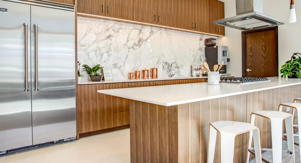 Luxury kitchen with a large island, stainless steel Viking appliances, and elegant marble backsplash at NEXT Apartments in Chicago