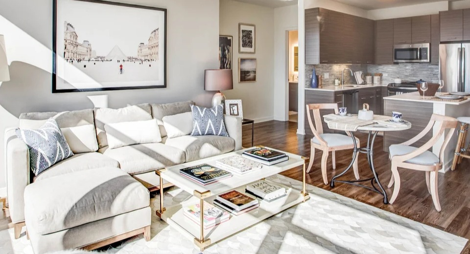 Spacious open-concept living room and kitchen area with modern furnishings, ideal for entertaining at NEXT Apartments Chicago