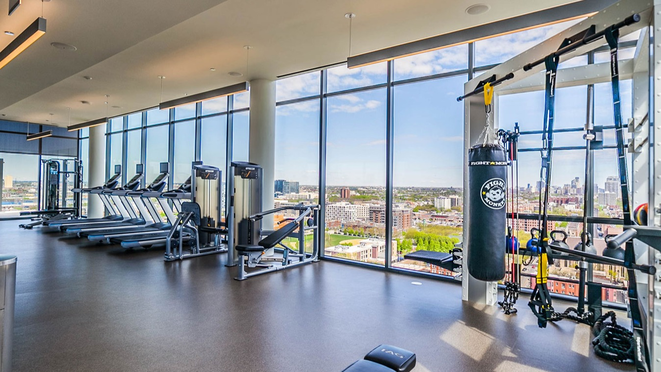 State-of-the-art fitness center at Niche 905 in Chicago, featuring a variety of cardio and strength equipment with panoramic city views