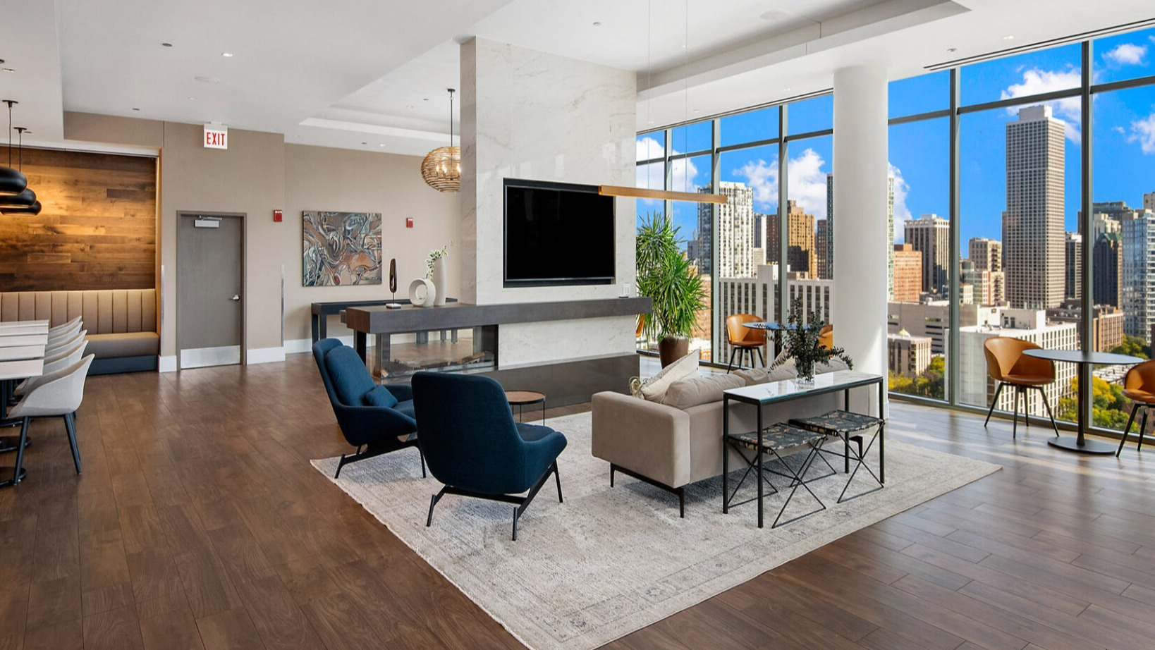 Elegant resident lounge at Niche 905 in Chicago, featuring a modern fireplace, comfortable seating, and city views through large windows