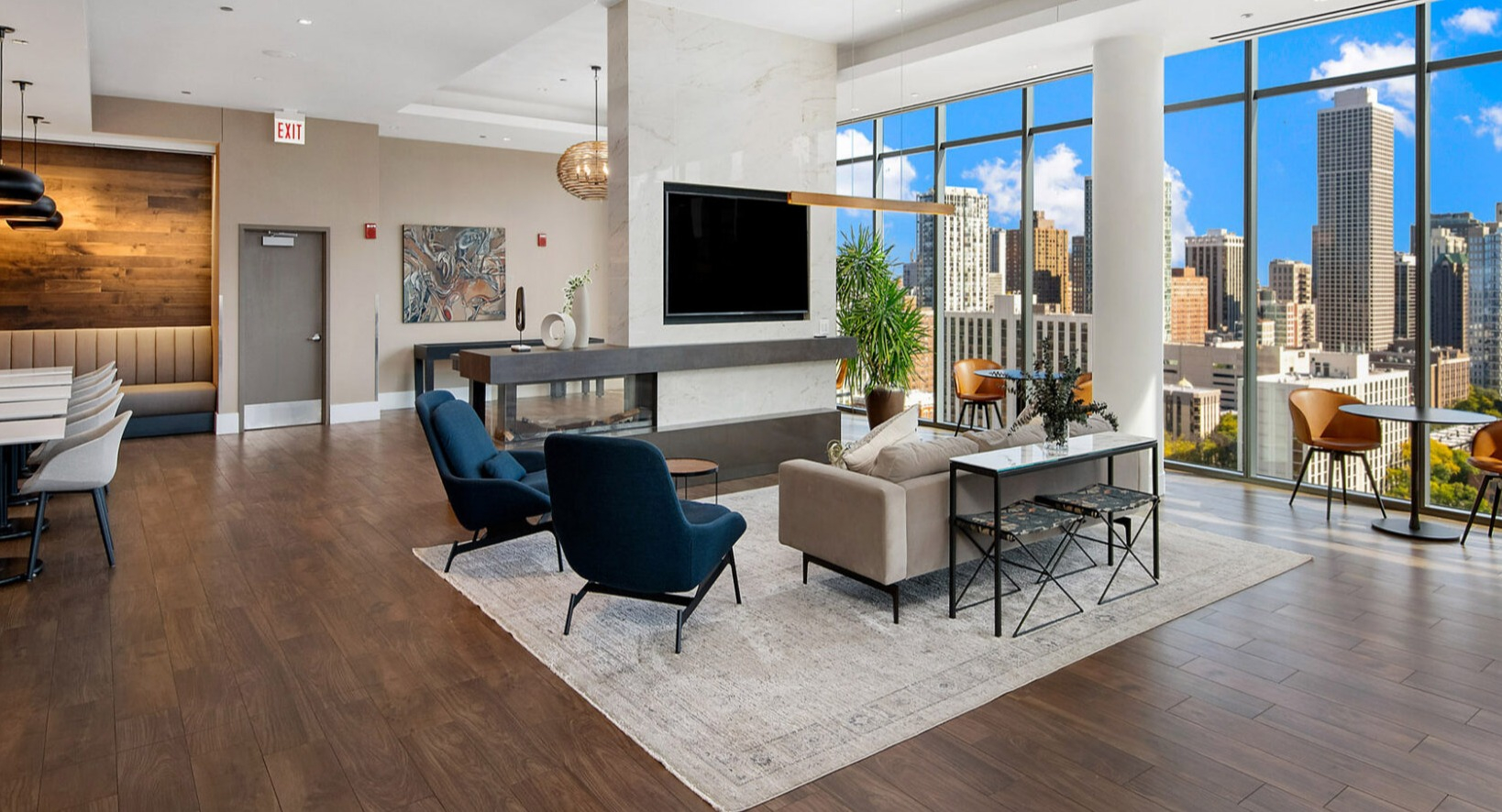 Elegant resident lounge at Niche 905 in Chicago, featuring a modern fireplace, comfortable seating, and city views through large windows