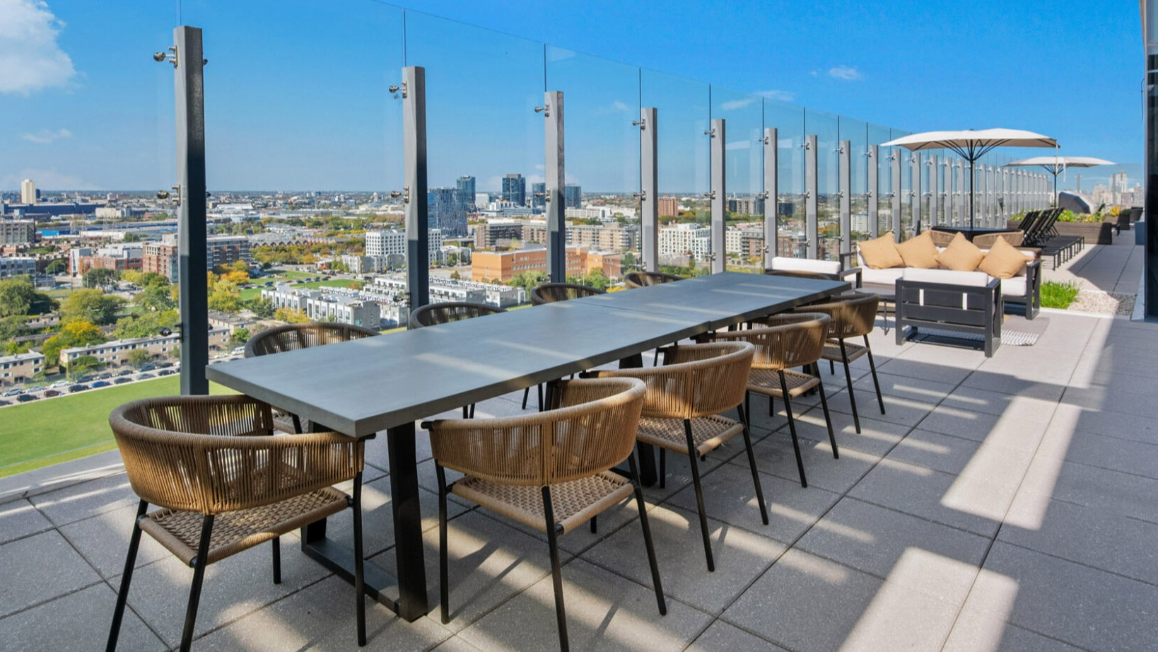 Expansive rooftop terrace at Niche 905 in Chicago, offering multiple dining and lounge areas with incredible city vistas