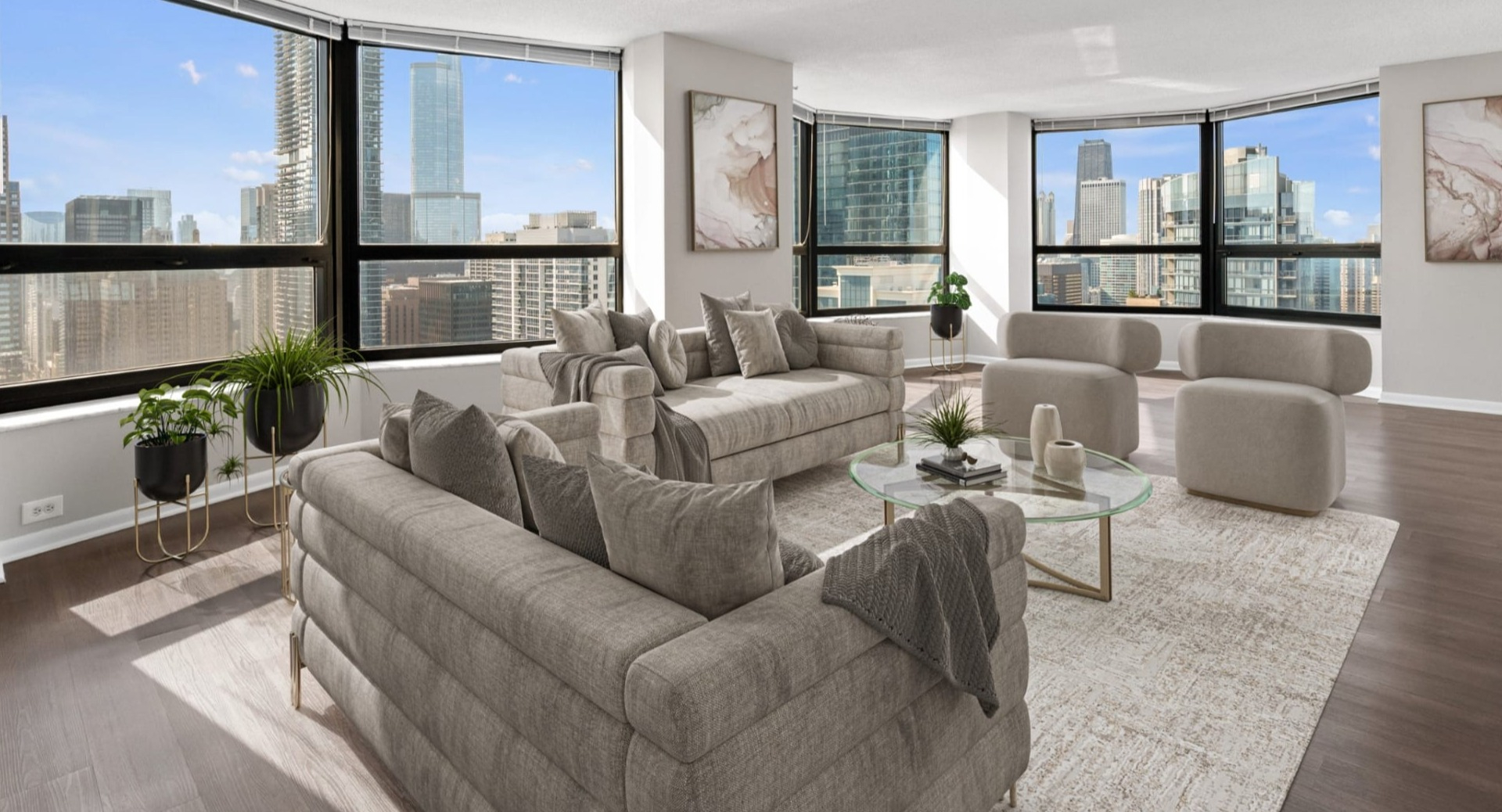 Spacious living room at North Harbor Tower with curved windows, modern gray seating, and sweeping Chicago skyline views flooding the space with light