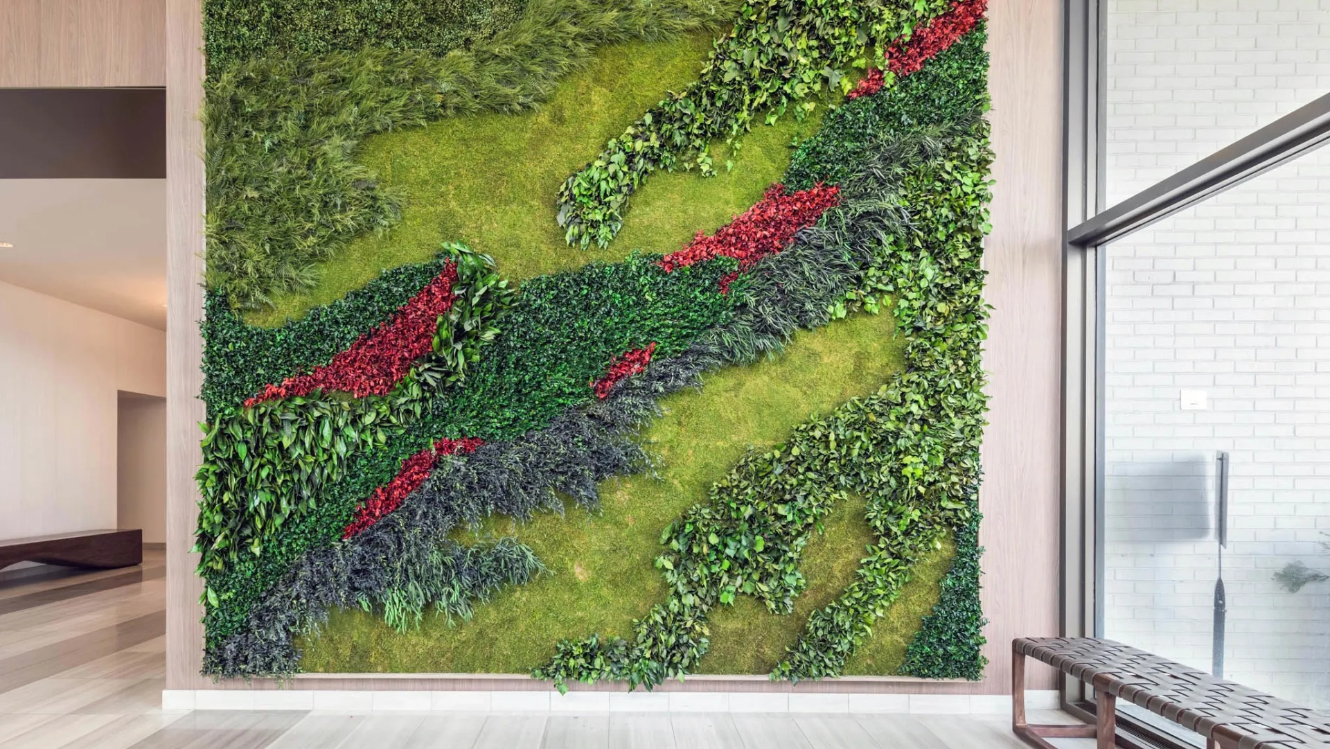 Elegant lobby at North Harbor Tower in Chicago featuring a striking living green wall with vibrant plants and a bench, creating a fresh, modern welcome for residents