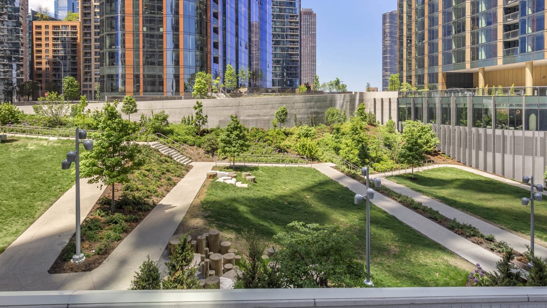 Outdoor garden and landscaped walking paths at North Harbor Tower in Chicago, surrounded by greenery and high-rise views