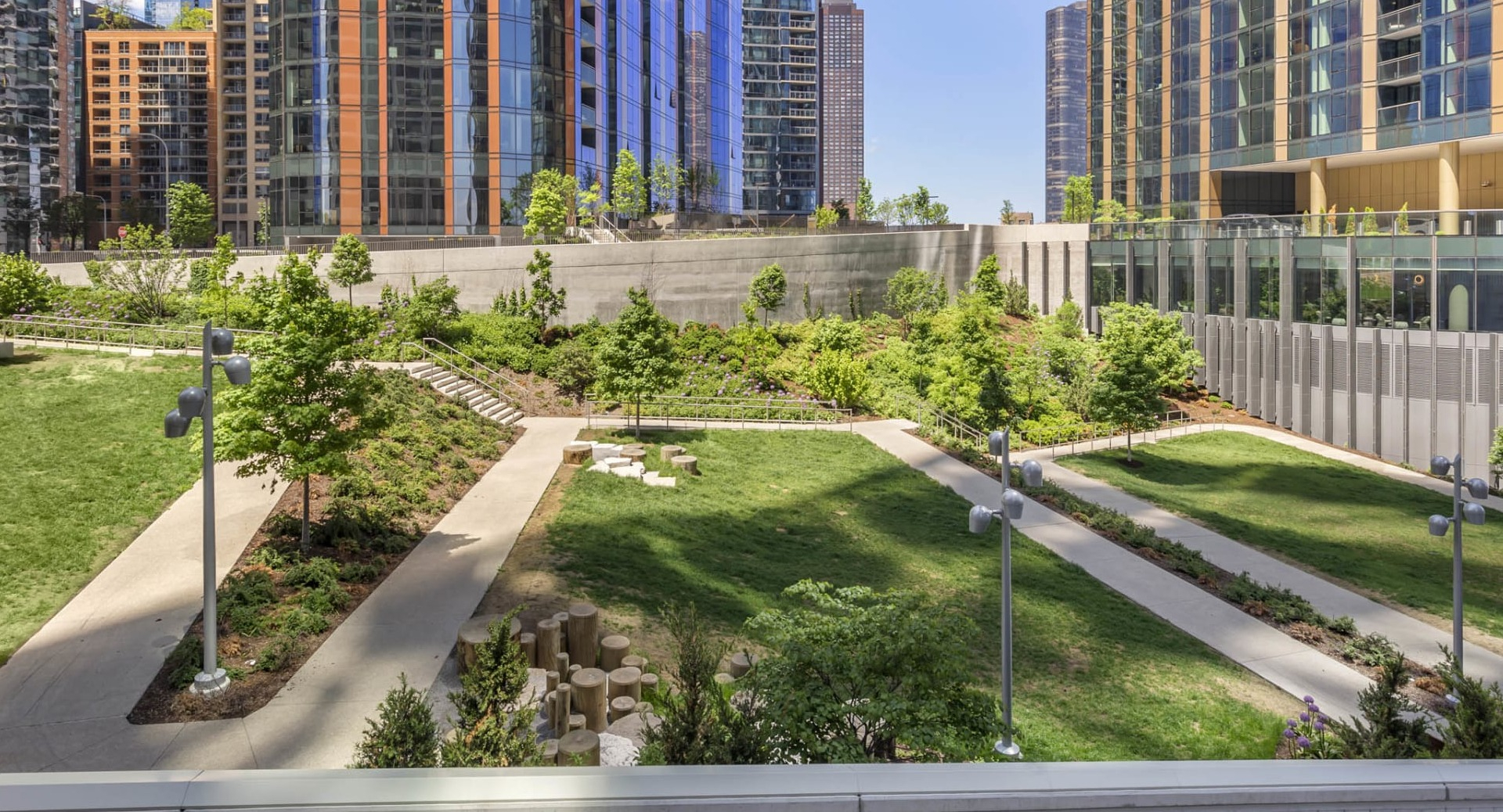 Outdoor garden and landscaped walking paths at North Harbor Tower in Chicago, surrounded by greenery and high-rise views
