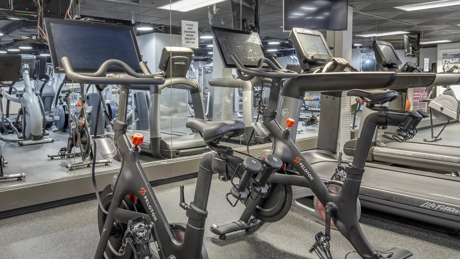 Cardio room at North Harbor Tower in Chicago featuring Peloton bikes, treadmills, and mirrored walls for modern workout experiences