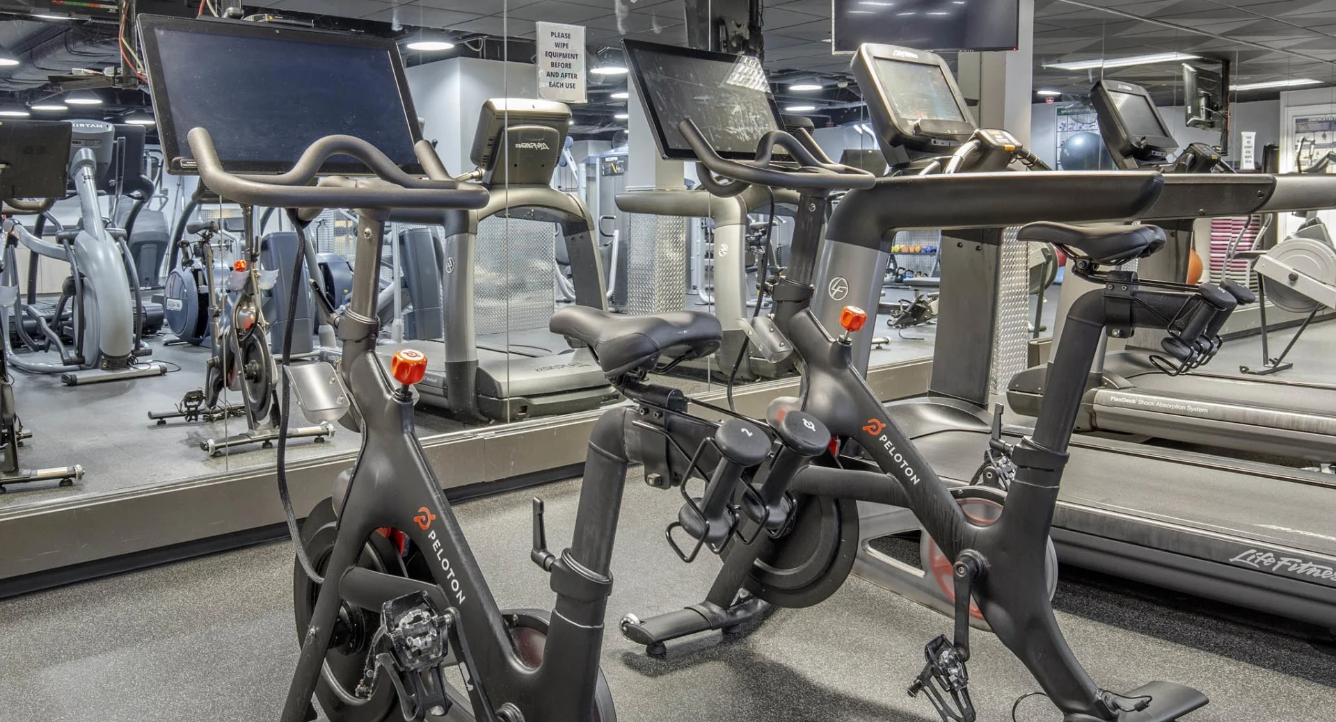 Cardio room at North Harbor Tower in Chicago featuring Peloton bikes, treadmills, and mirrored walls for modern workout experiences