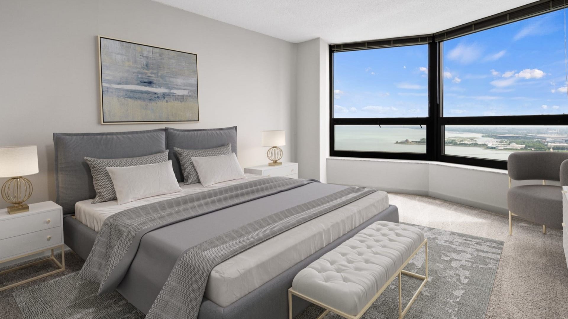 Serene primary bedroom at North Harbor Tower featuring a plush bed, neutral décor, and a wide lake and city outlook through expansive Chicago windows