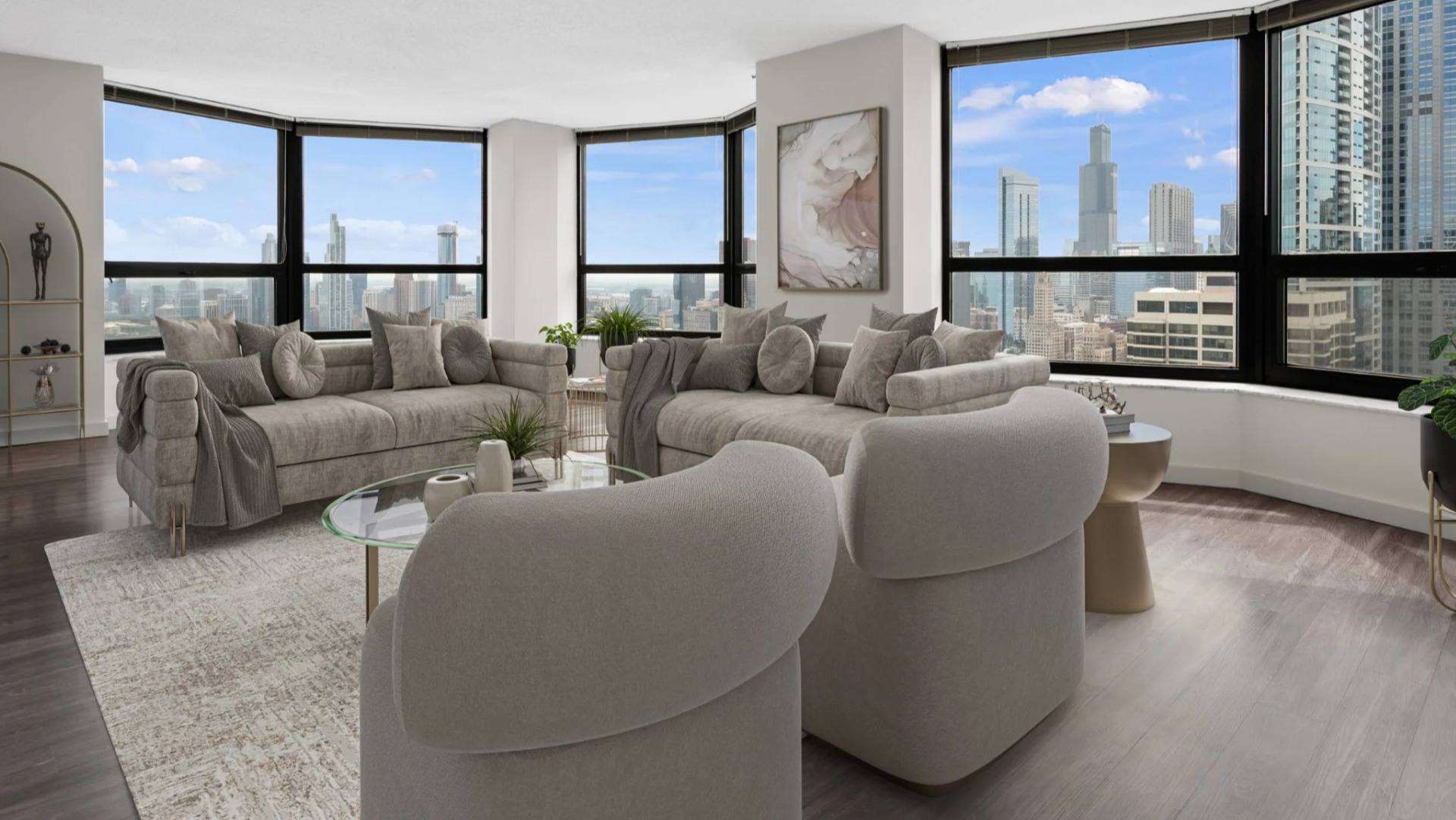 Bright, spacious living room at North Harbor Tower with modern sofas, glass coffee table, and panoramic Chicago skyline views from large corner windows