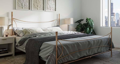 Elegant bedroom with a decorative metal bed frame, plush rug, and large windows showcasing city views at North+Vine in Chicago