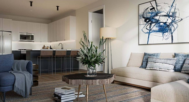 Modern open-concept kitchen and living room with stylish furniture, a breakfast bar, and contemporary art at North+Vine in Chicago
