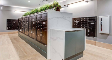Modern and secure mailroom with individual mailboxes and a package area, designed for resident convenience at North+Vine in Chicago