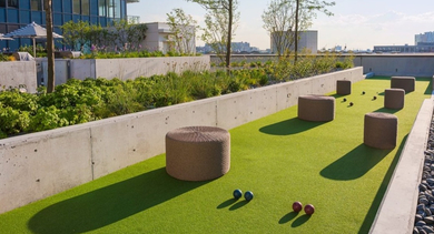 Scenic outdoor bocce ball court surrounded by greenery, offering a fun recreational activity at OLD TOWN PARK ONE in Chicago