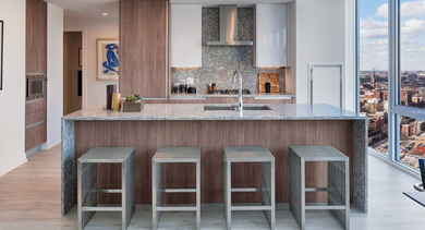Sleek kitchen with a large granite island, bar seating, and expansive windows offering impressive city views at OLD TOWN PARK ONE in Chicago