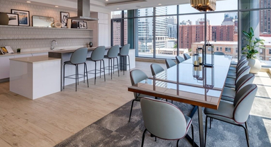 Elegant private dining room with a long table, modern chairs, and an adjacent full kitchen for entertaining at OLD TOWN PARK ONE in Chicago