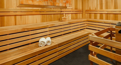Luxurious wooden sauna with tiered benches, warm lighting, and a soothing atmosphere at OLD TOWN PARK ONE in Chicago