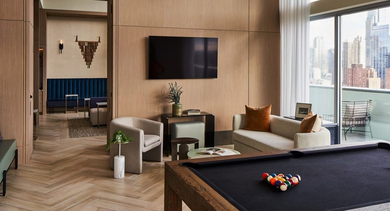 Elegant billiards lounge with a pool table, comfortable seating, large windows, and a modern chandelier at OLD TOWN PARK THREE in Chicago