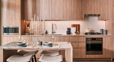 Stylish kitchen featuring light wood cabinetry, granite countertops, and stainless steel appliances, with an island at OLD TOWN PARK THREE in Chicago