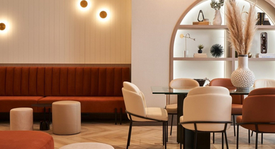 Stylish resident dining and lounge area with comfortable seating, a decorative shelving unit, and warm lighting at OLD TOWN PARK THREE in Chicago