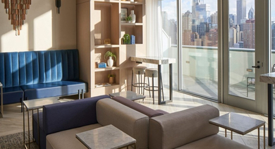 Sophisticated resident lounge with plush sofas, varied seating arrangements, and large windows offering urban views at OLD TOWN PARK THREE in Chicago